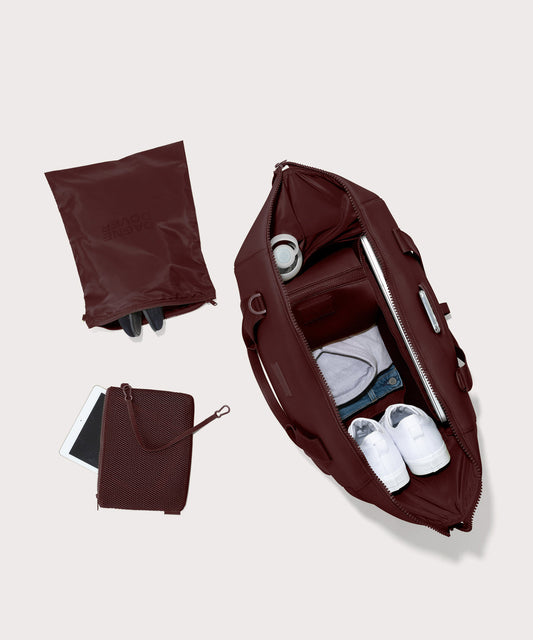 Dagne Dover Extra Large Landon Carryall in a deep brown with purple undertones unzipped, top down view.