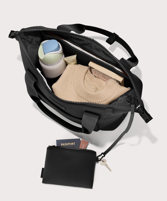 Tote bag in a black seen from the top down view showing interior mesh pouch.