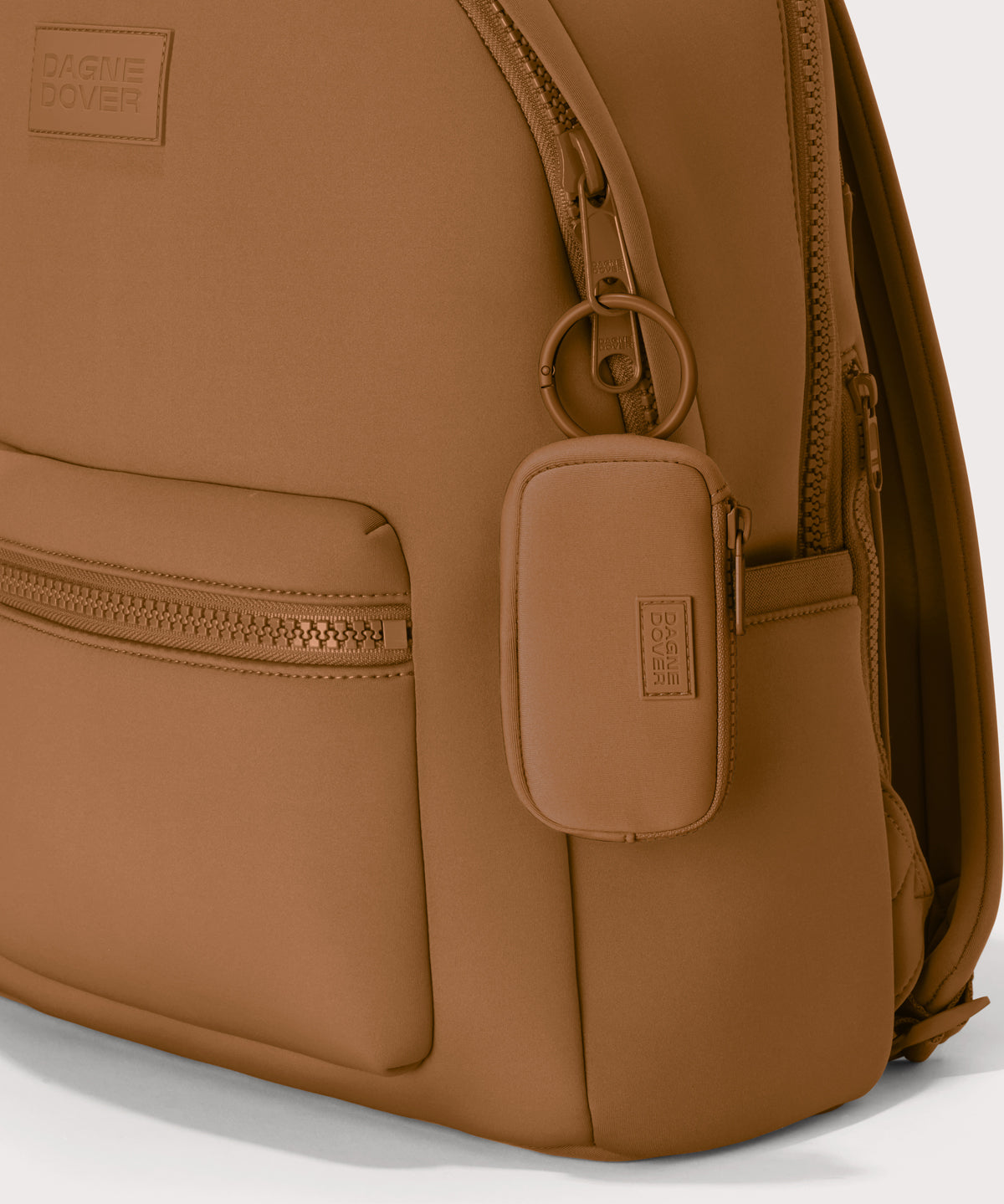 Mara Keychain in a saturated, warm medium-brown with burnt orange undertones. front angle showing keychain on a dakota backpack.