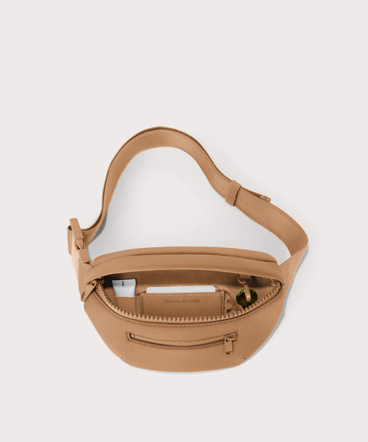 Dagne Dover Ace Fanny Pack in camel unzipped, exposing the interior pockets