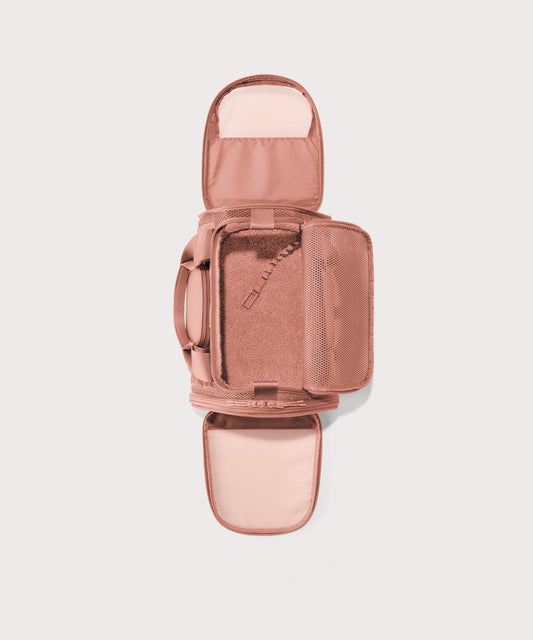 Dagne Dover small Kyoto Pet Carrier in a warm dust pink seen unzipped, top down view.