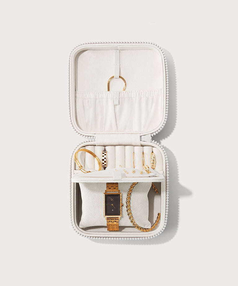 Dagne Dover Large Frankie Jewelry Case in white, seen open from above with jewelry inside the interior compartment.