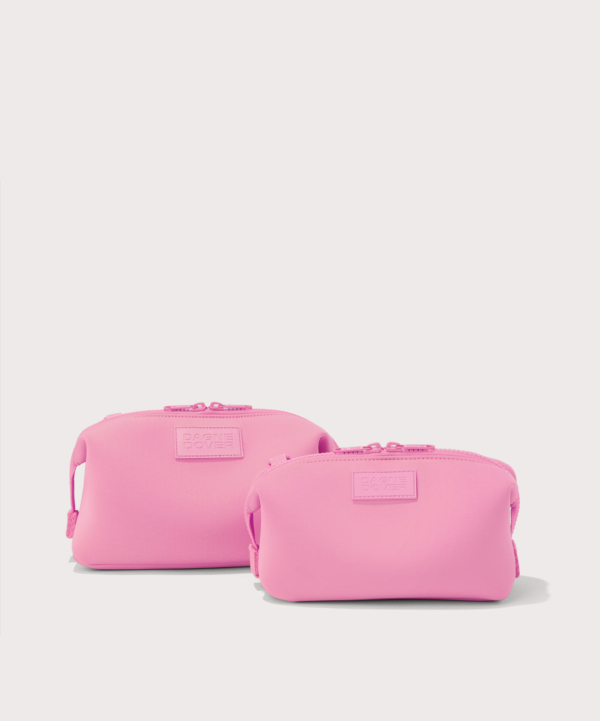 Dagne Dover Small and Large Hunter Toiletry Bags in a true bubble gum pink.