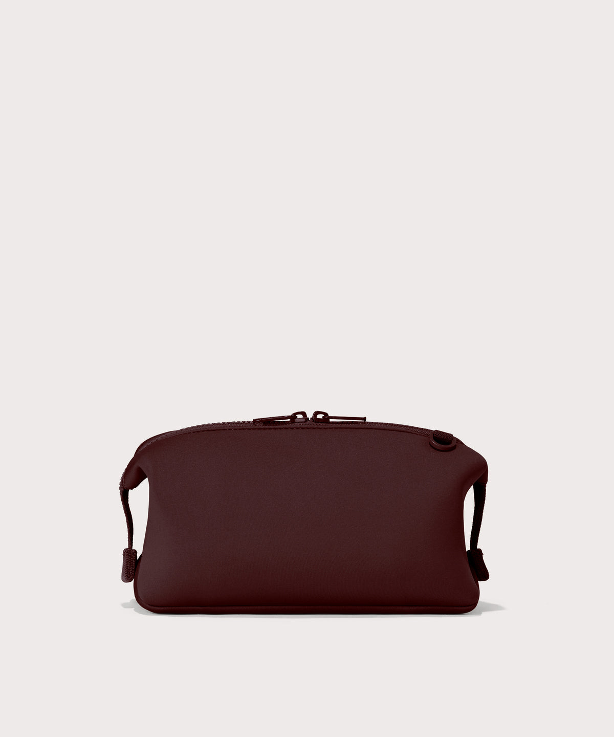 Dagne Dover Large Hunter Toiletry Bag in a deep brown with purple undertones seen from the back.