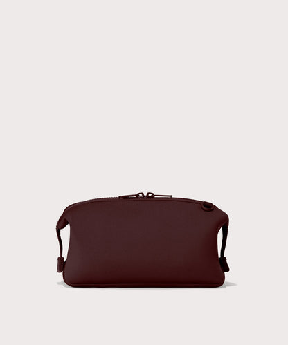 Dagne Dover Large Hunter Toiletry Bag in a deep brown with purple undertones seen from the back.