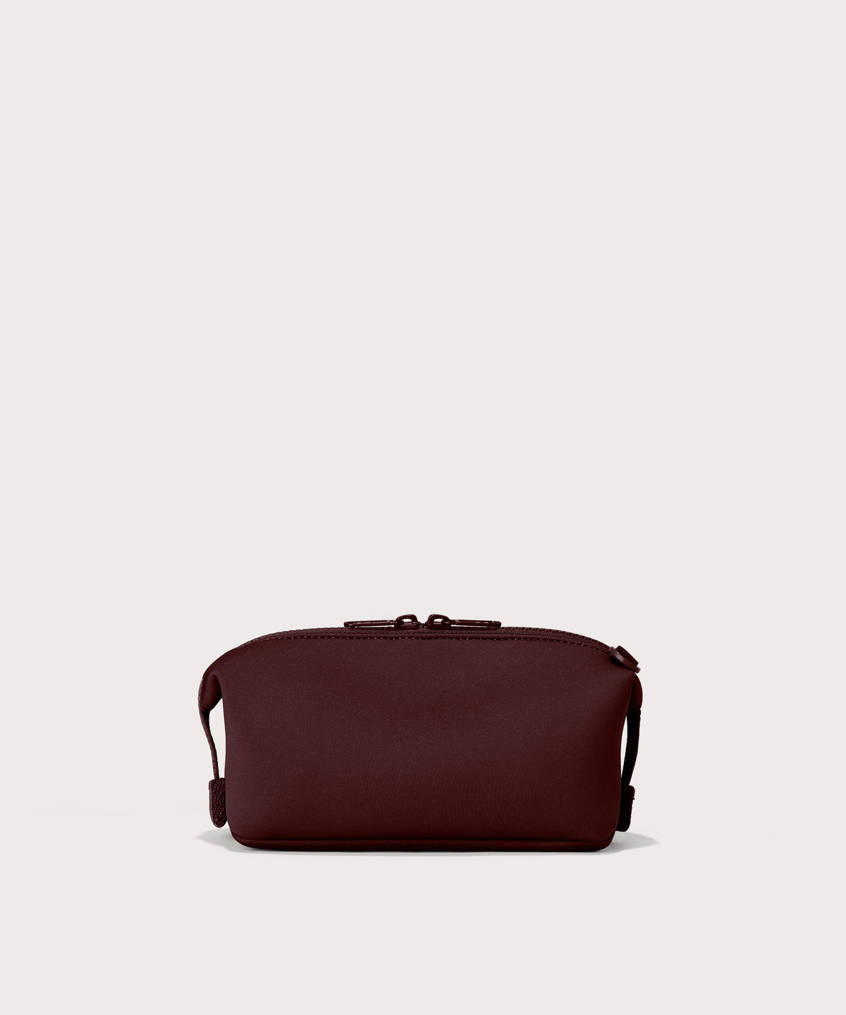 Dagne Dover Large Hunter Toiletry Bag in a deep brown with purple undertones seen from the back.