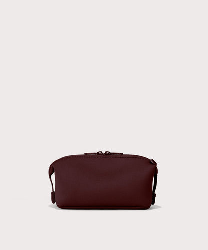 Dagne Dover Large Hunter Toiletry Bag in a deep brown with purple undertones seen from the back.