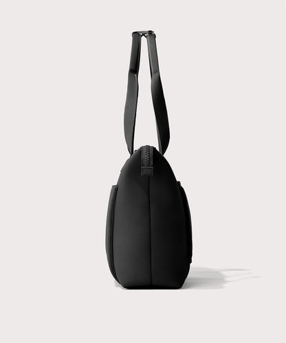 Tote bag in a black seen from the side view.