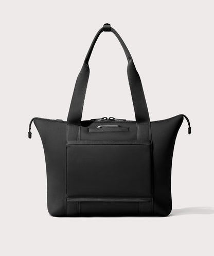 Tote bag in a black seen from the back view showing phone pocket.’