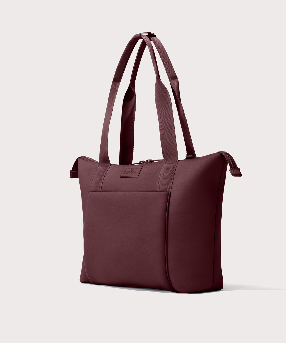 Tote bag in a deep brown with purple undertones reminiscent of maroon seen from the angle view .
