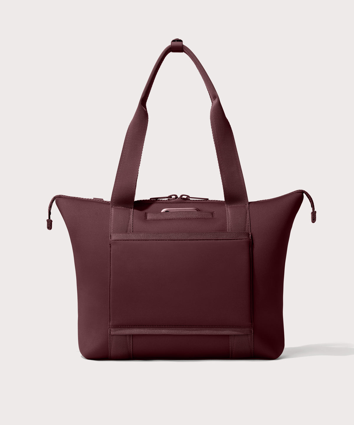 Tote bag in a deep brown with purple undertones reminiscent of maroon seen from the back view showing phone pocket.
