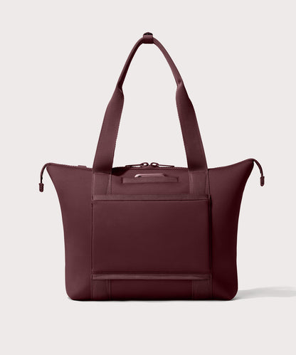 Tote bag in a deep brown with purple undertones reminiscent of maroon seen from the back view showing phone pocket.