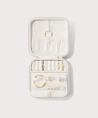 Dagne Dover Large Frankie Jewelry Case in white, seen open from above with jewelry inside the interior compartment.