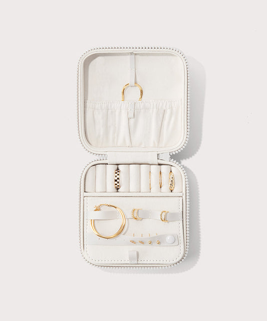 Dagne Dover Large Frankie Jewelry Case in white, seen open from above with jewelry inside the interior compartment.