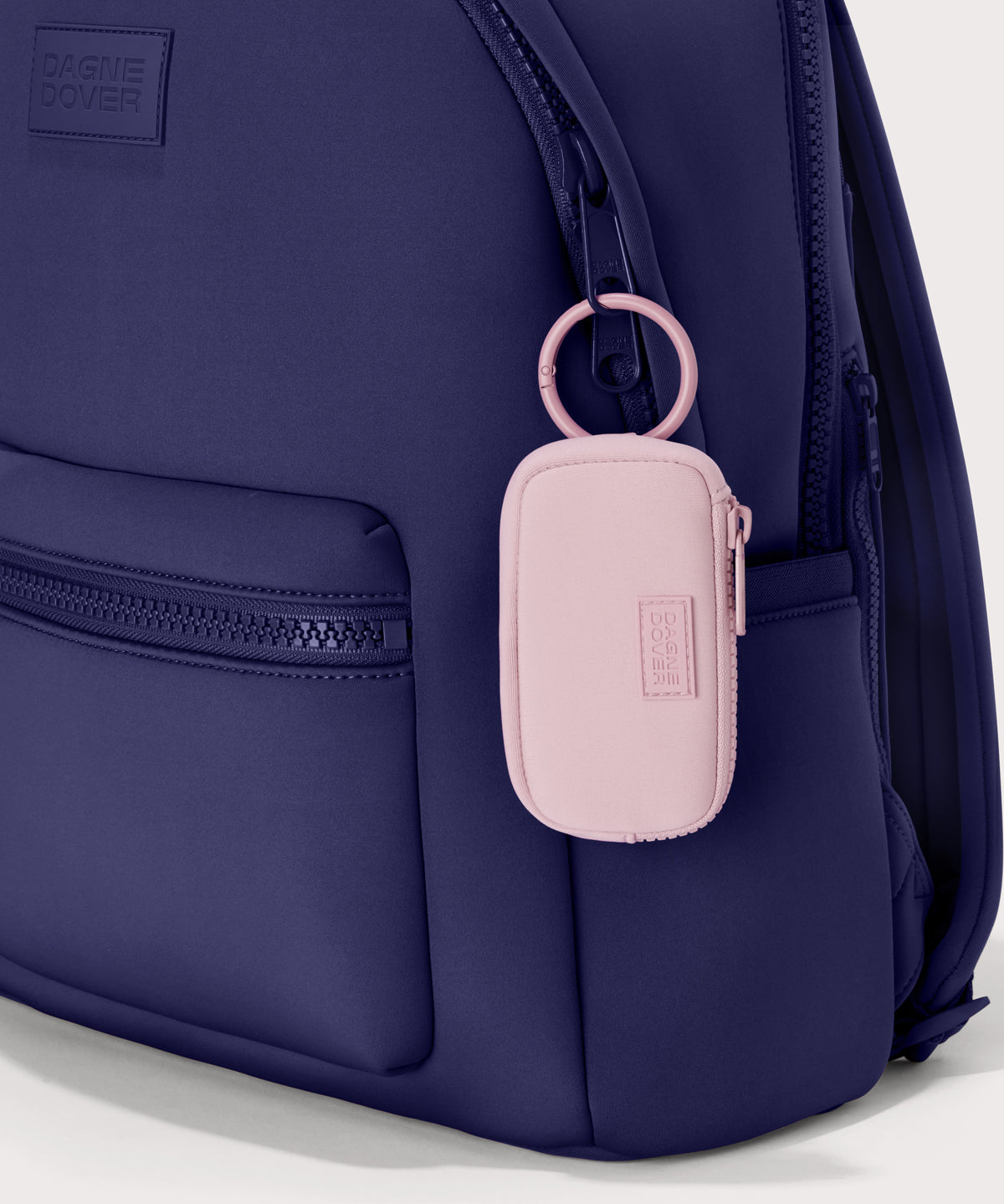 Mara Keychain in a cool, powdery pink with soft grey undertones. front view. showing keychain on a dakota backpack.