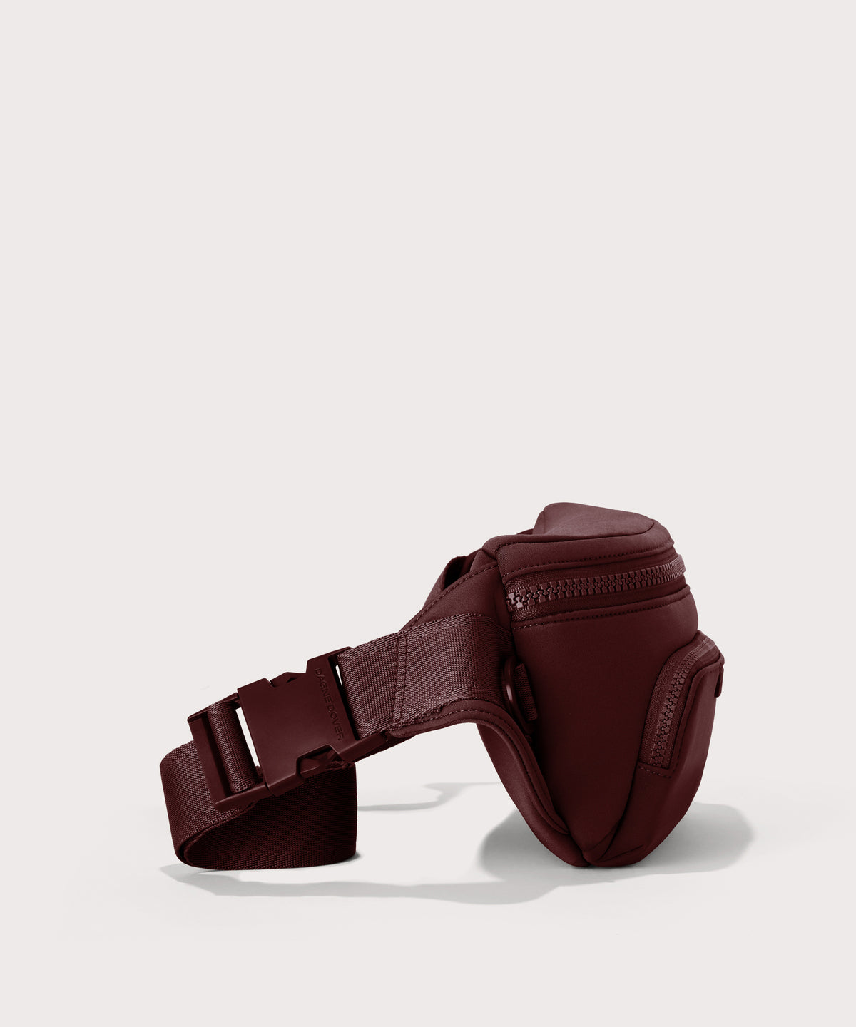 Dagne Dover Jax Large Fanny Pack in a deep brown with purple undertones seen from the side.