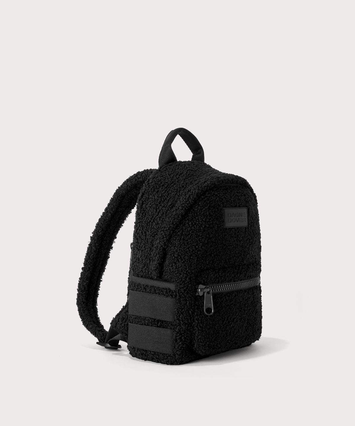 Dakota Small backpack pack in a black. side angle view In a black Faux Shearling a soft, wool-like plush made with recycled materials