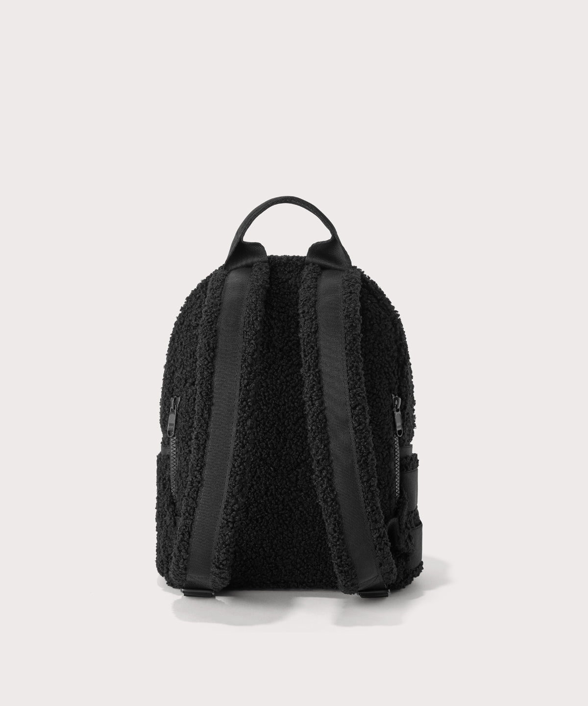 Dakota Small backpack pack in a black Back view. In a Faux Shearling a soft, wool-like plush made with recycled materials