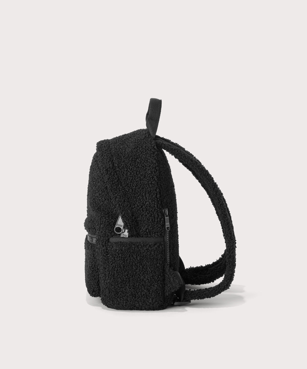 Dakota Small backpack pack in a black, side view In a Faux Shearling a soft, wool-like plush made with recycled materials