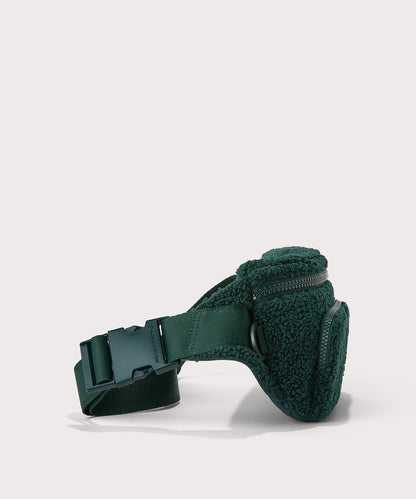 Jax fanny pack in a saturated, jewel-toned deep green with bold blue undertones. Side View. In a Faux Shearling a soft, wool-like plush made with recycled materials