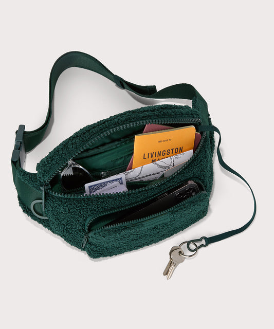 Jax fanny pack in a saturated, jewel-toned deep green with bold blue undertones. Top down view. In a Faux Shearling a soft, wool-like plush made with recycled materials