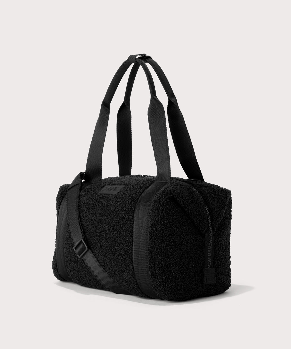 Medium landon carryall in a black. side angle view In a Faux Shearling a soft, wool-like plush made with recycled materials