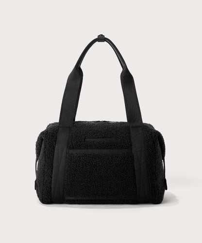 Medium landon carryall in a black. Back view. In a Faux Shearling a soft, wool-like plush made with recycled materials