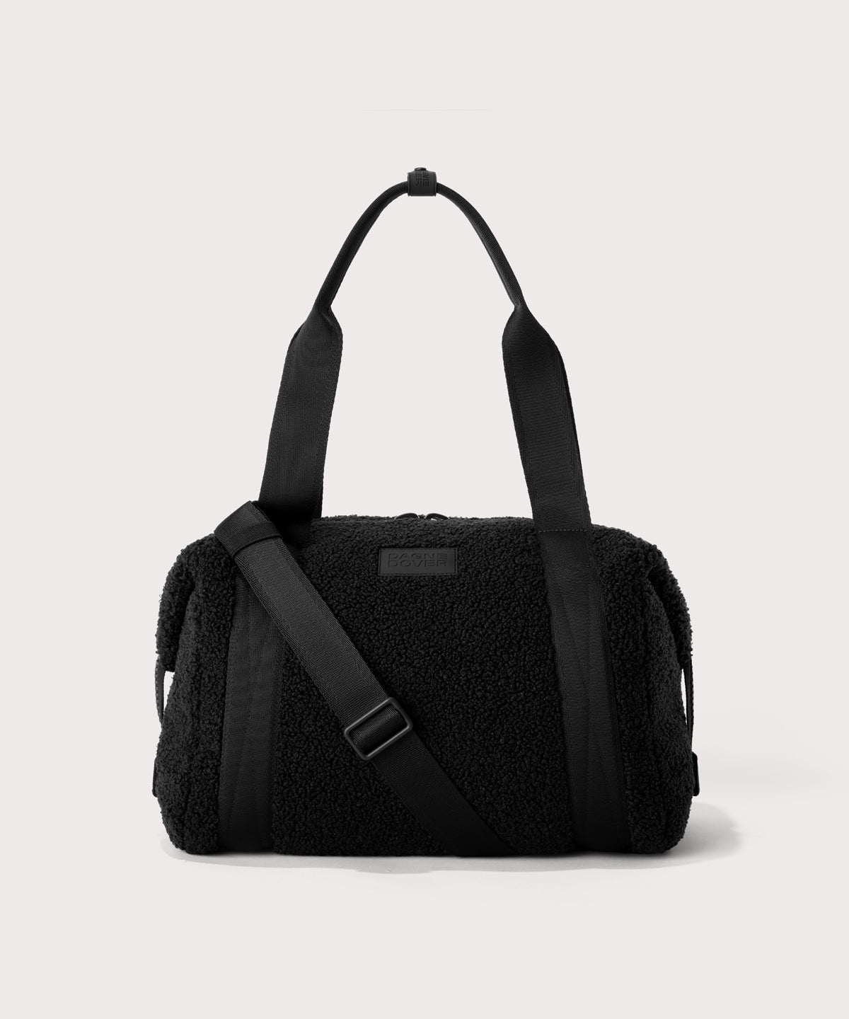 Medium landon carryall in a black. In a Faux Shearling a soft, wool-like plush made with recycled materials. front angle.