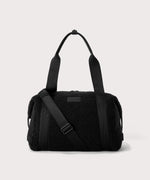 Medium landon carryall in a black. In a Faux Shearling a soft, wool-like plush made with recycled materials. front angle.