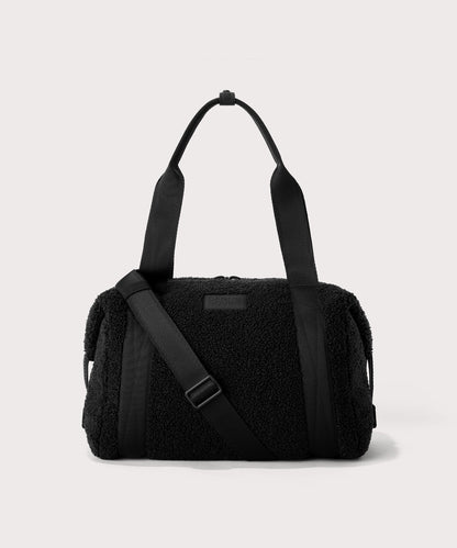 Medium landon carryall in a black. In a Faux Shearling a soft, wool-like plush made with recycled materials. front angle.