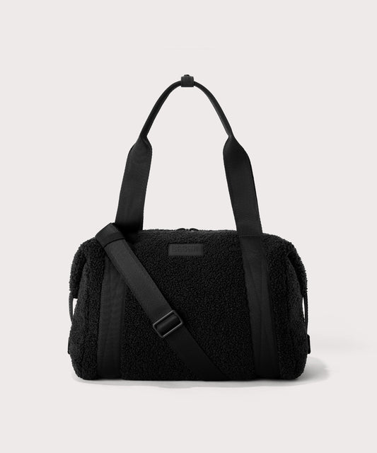 Medium landon carryall in a black. In a Faux Shearling a soft, wool-like plush made with recycled materials. front angle.