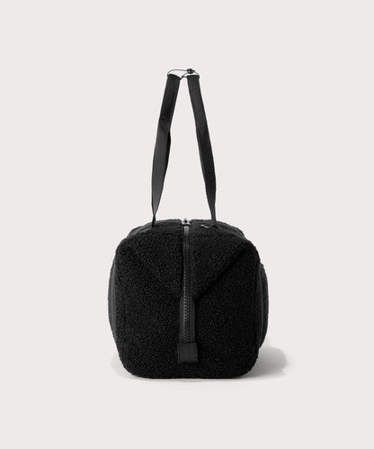 Medium landon carryall in a black., side view In a Faux Shearling a soft, wool-like plush made with recycled materials