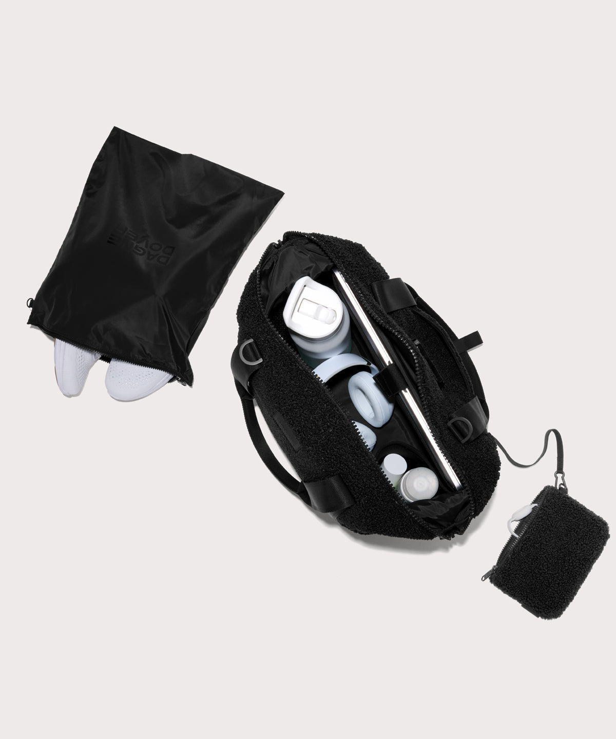 Medium landon carryall in a black. . unzipped, top down view. In a Faux Shearling a soft, wool-like plush made with recycled materials
