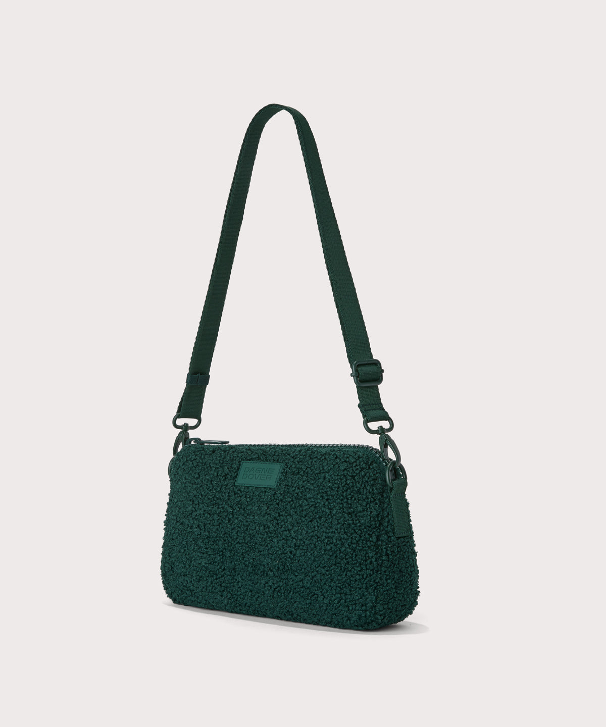 nora shoulder bag in a saturated, jewel-toned deep green with bold blue undertones.. side angle view In a Faux Shearling a soft, wool-like plush made with recycled materials