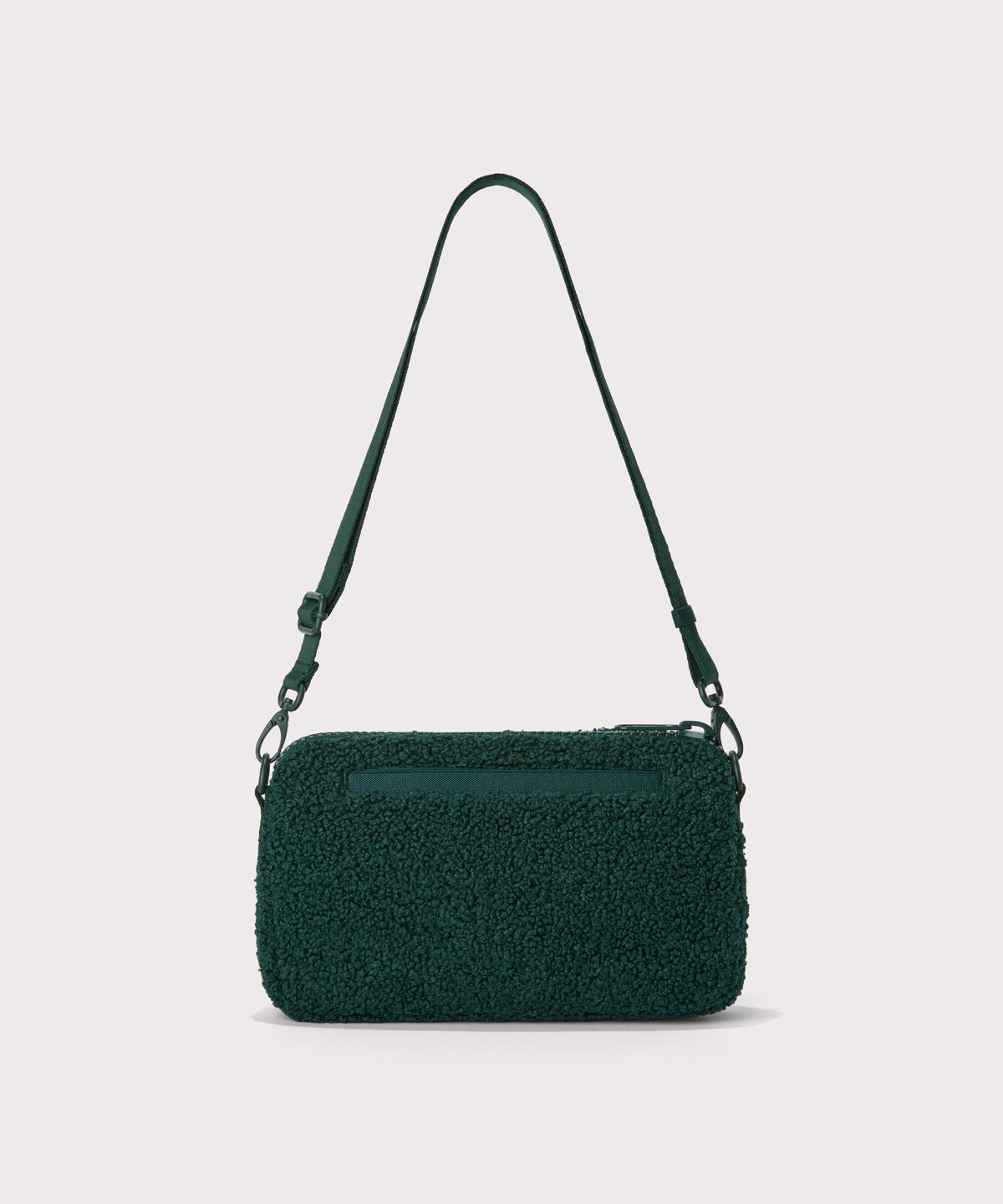 nora shoulder bag in a saturated, jewel-toned deep green with bold blue undertones. Back view. In a Faux Shearling a soft, wool-like plush made with recycled materials