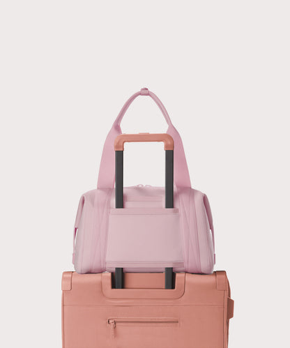Medium Landon Carryall in a cool, powdery pink with soft grey undertones displaying luggage sleeve