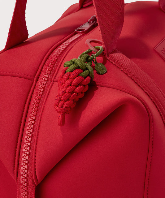 Dagne Dover Picante Keychain in a fiery, saturated red leaning toward orange clipped onto a bag.
