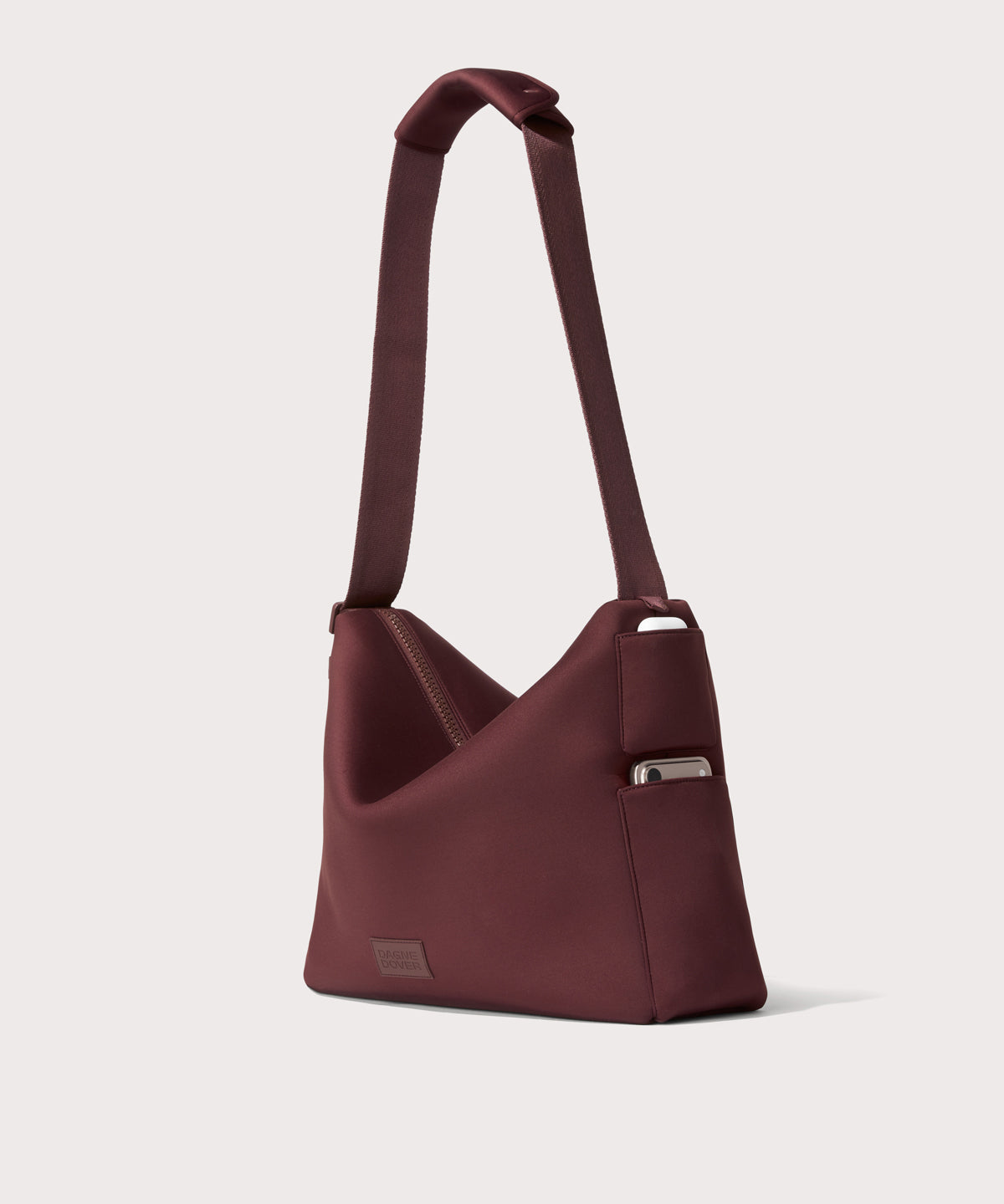 Large Shoulder bag in a deep brown with purple undertones reminiscent of maroon seen from the angle view showing phone pocket.