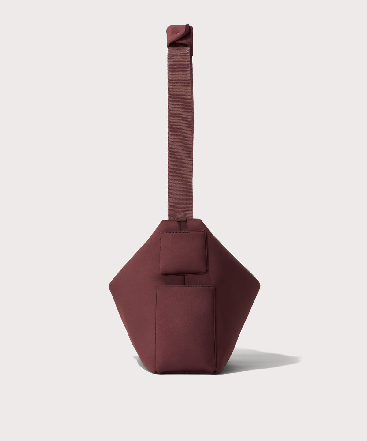 Large Shoulder bag in a deep brown with purple undertones reminiscent of maroon seen from the side view showing phone pocket.