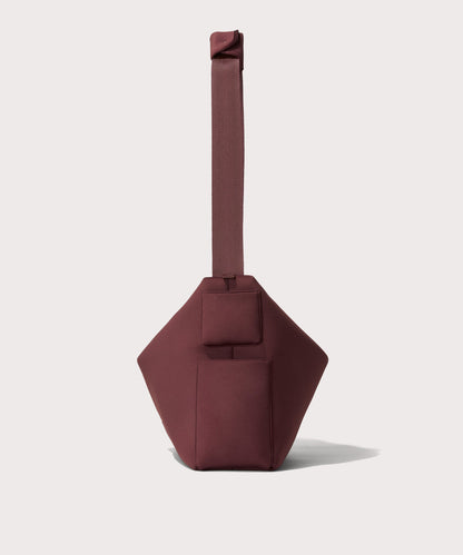Large Shoulder bag in a deep brown with purple undertones reminiscent of maroon seen from the side view showing phone pocket.