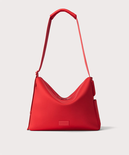 Dagne Dover Enzo Messenger Bag in Cherry, a bright red shoulder bag with a wide strap and a triangular shape