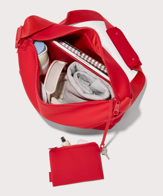 Large Shoulder bag in a fiery, saturated red leaning toward orange seen from the top down view showing interior mesh pouch.