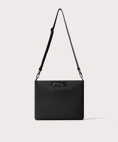 14 inch laptop shoulder bag in a black seen from the back view showing phone pocket.’