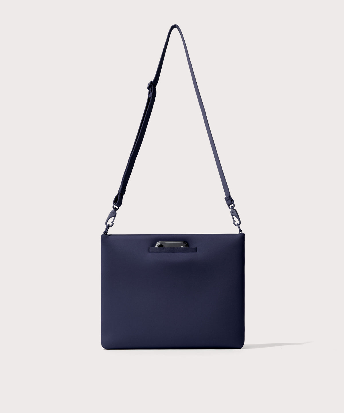 14 inch laptop shoulder bag in navy blue seen from the back view showing phone pocket.