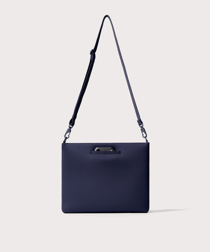 14 inch laptop shoulder bag in navy blue seen from the back view showing phone pocket.