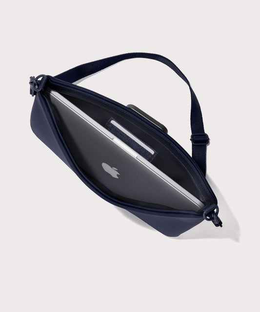 14 inch laptop shoulder bag in a navy blue seen from the top down view showing interior.