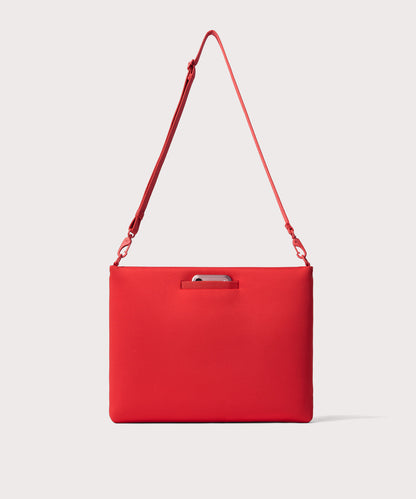 16 inch laptop shoulder bag in a fiery, saturated red leaning toward orange seen from the back view showing phone pocket.