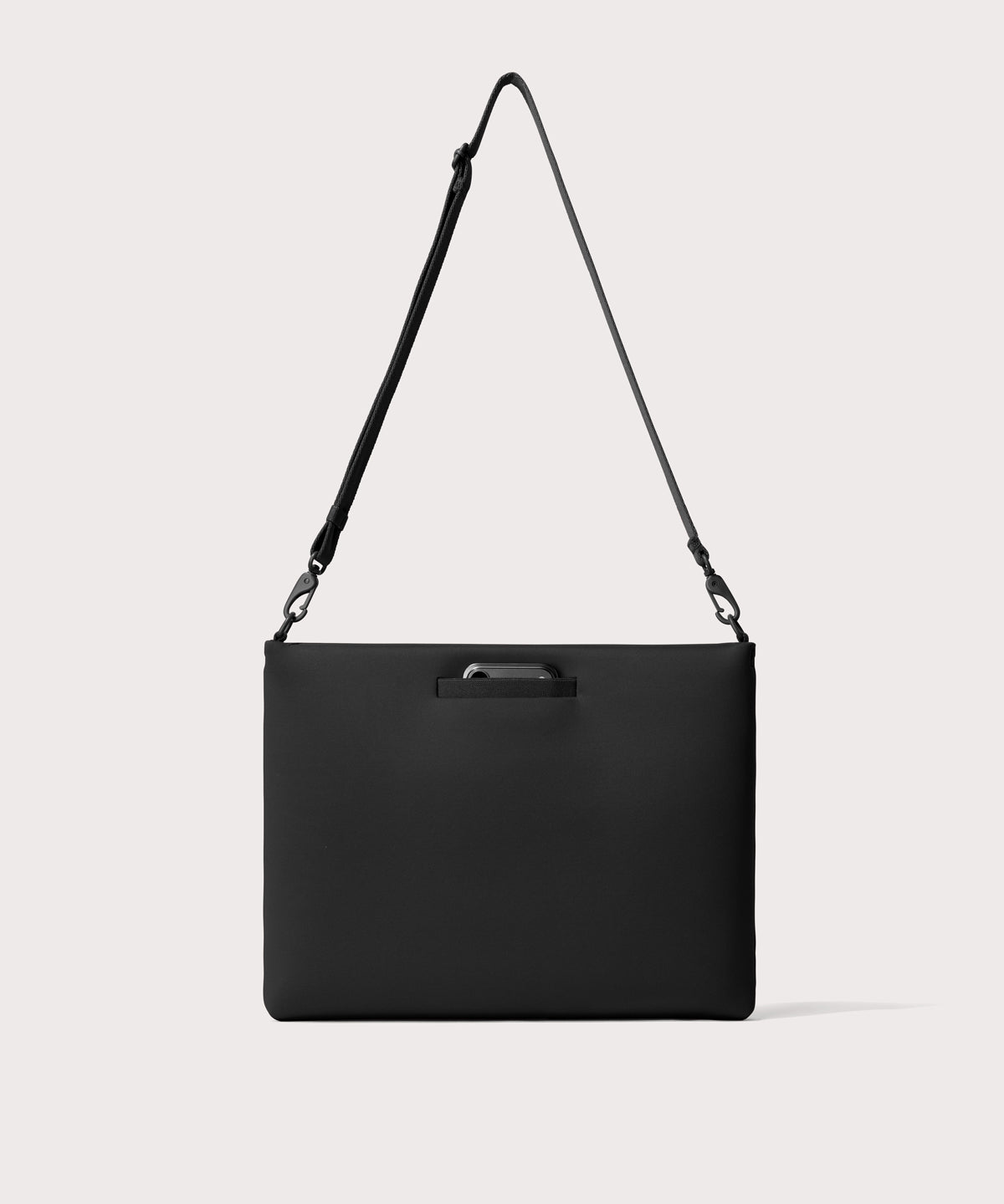 16 inch laptop shoulder bag in a black seen from the back view showing phone pocket.’