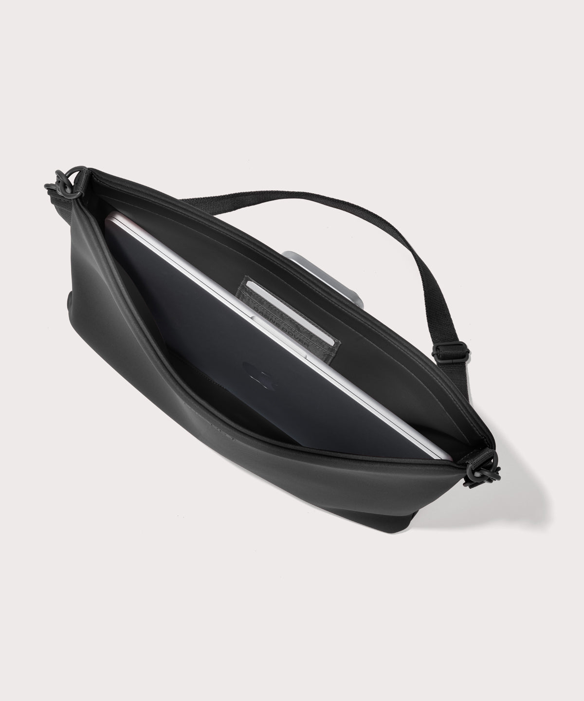 16 inch laptop shoulder bag in a black seen from the top down view showing interior.