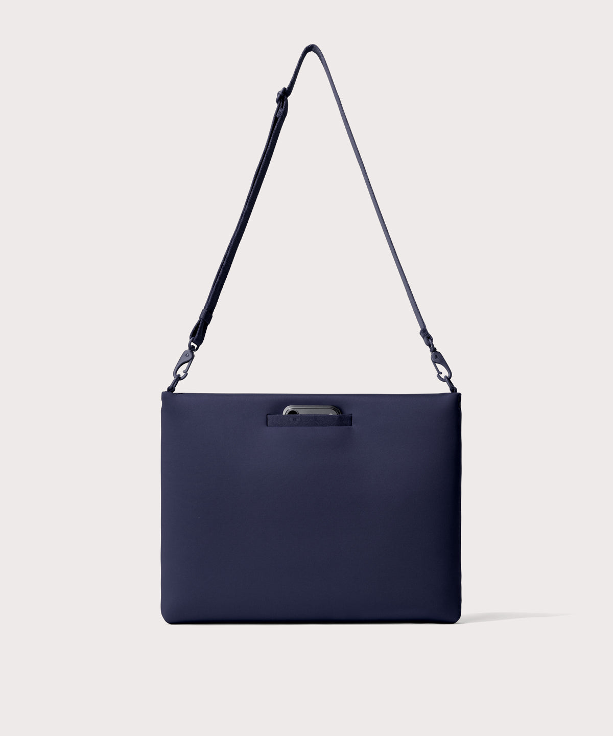 16 inch laptop shoulder bag in navy blue seen from the back view showing phone pocket.